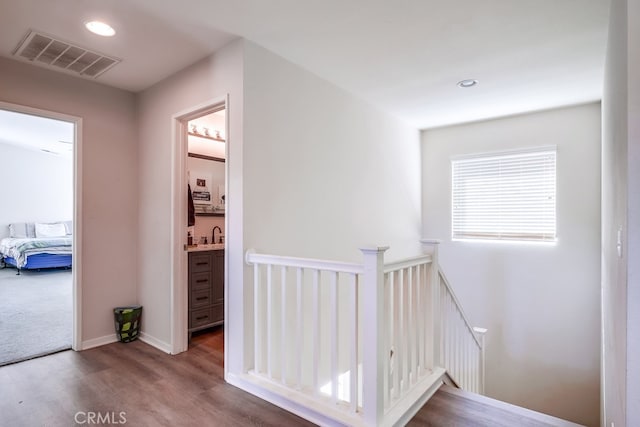 hall featuring hardwood / wood-style floors and sink