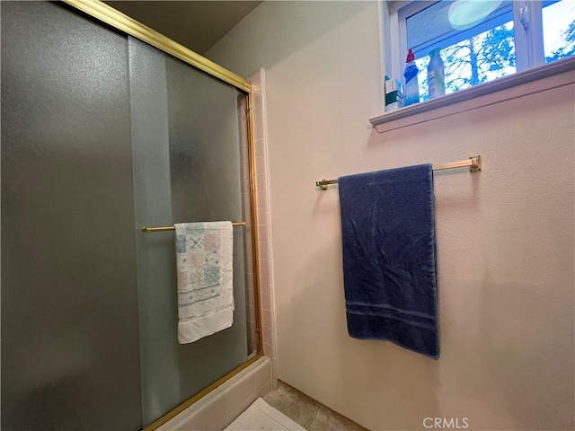 bathroom featuring a shower with door