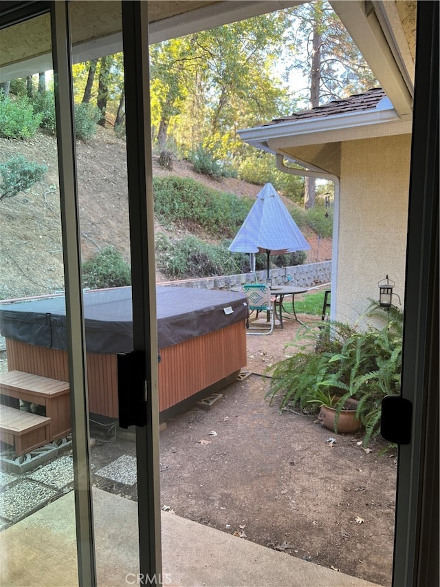 view of patio / terrace with a hot tub