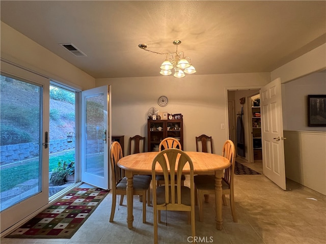 dining area with an inviting chandelier