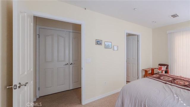 carpeted bedroom featuring a closet