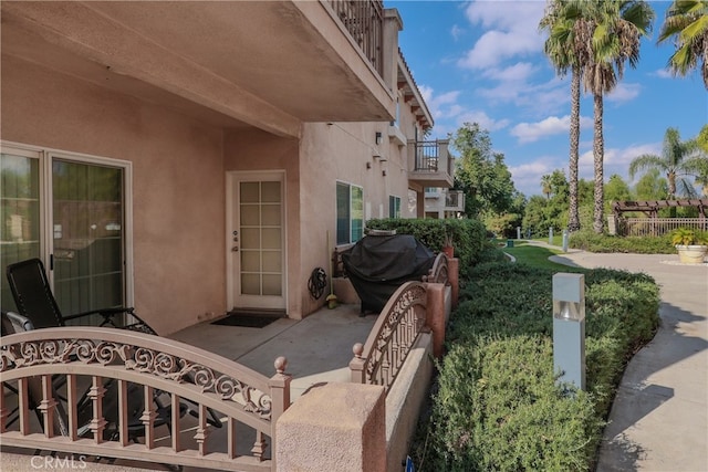 view of patio featuring a balcony and grilling area