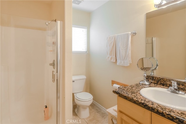 bathroom featuring vanity, a shower, toilet, and tile patterned floors