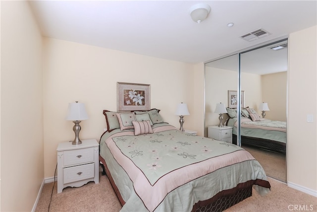 bedroom with a closet and light colored carpet