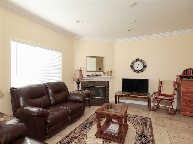 living room featuring crown molding, light tile patterned flooring, and a fireplace