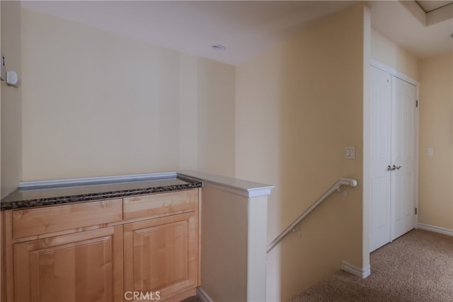 hallway with light colored carpet