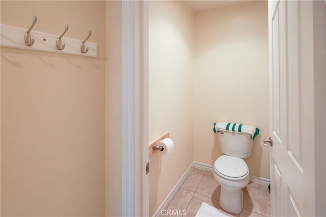 bathroom with toilet and tile patterned flooring