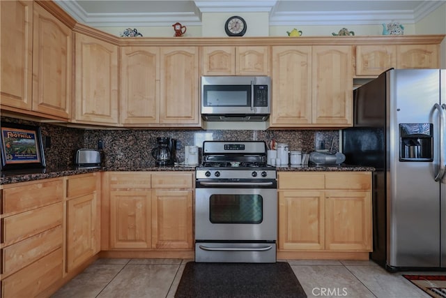 kitchen featuring crown molding, light brown cabinets, stainless steel appliances, and dark stone countertops