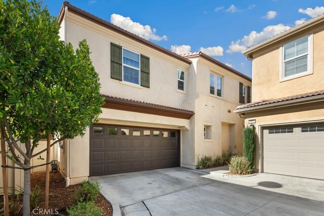 mediterranean / spanish-style house with a garage