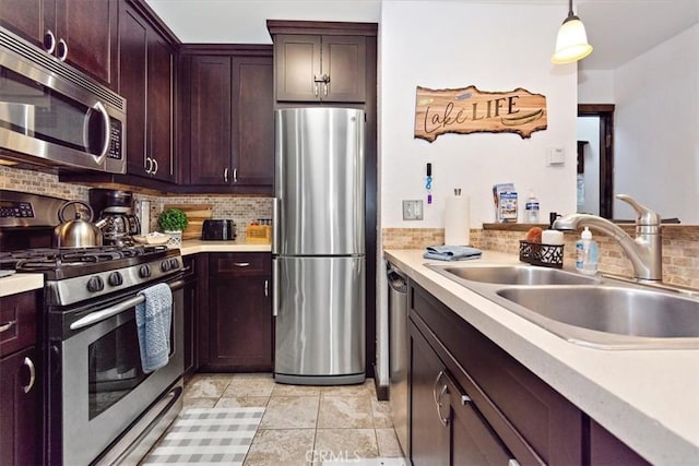 760 Blue Jay Rd Unit 10, Big Bear Lake, CA 92315 - kitchen with stainless steel appliances, a sink, tasteful backsplash, light countertops, and pendant lighting