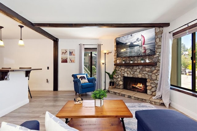 760 Blue Jay Rd Unit 10, Big Bear Lake, CA 92315 - living area with beamed ceiling, a fireplace, baseboards, and light wood finished floors