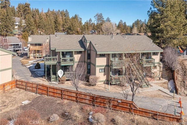 760 Blue Jay Rd Unit 10, Big Bear Lake, CA 92315 - rear view of property featuring roof with shingles and a balcony