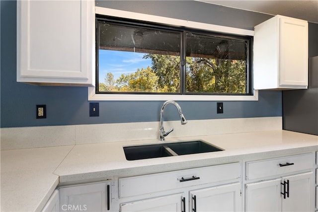 kitchen with sink and white cabinetry