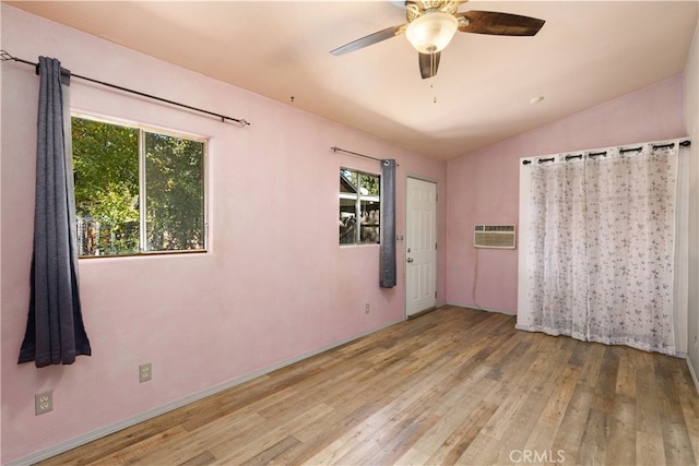 unfurnished room with lofted ceiling, light wood-type flooring, and a wealth of natural light