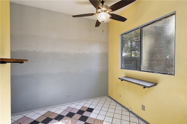 empty room featuring light tile patterned floors and ceiling fan