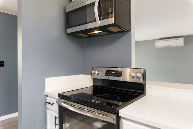 kitchen with stainless steel appliances and a wall unit AC