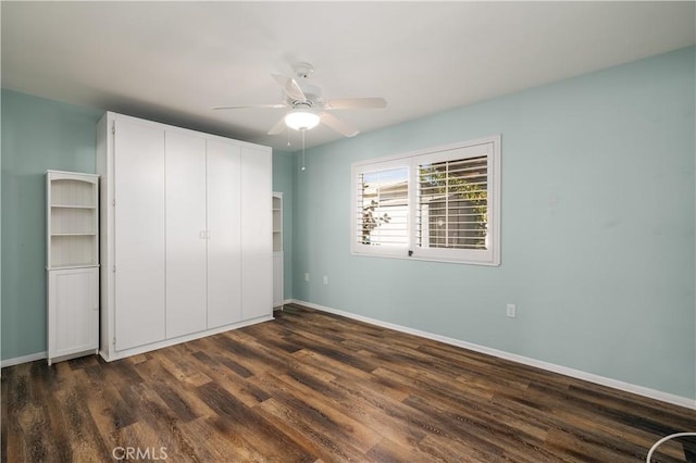 unfurnished bedroom featuring a closet, ceiling fan, and dark hardwood / wood-style flooring