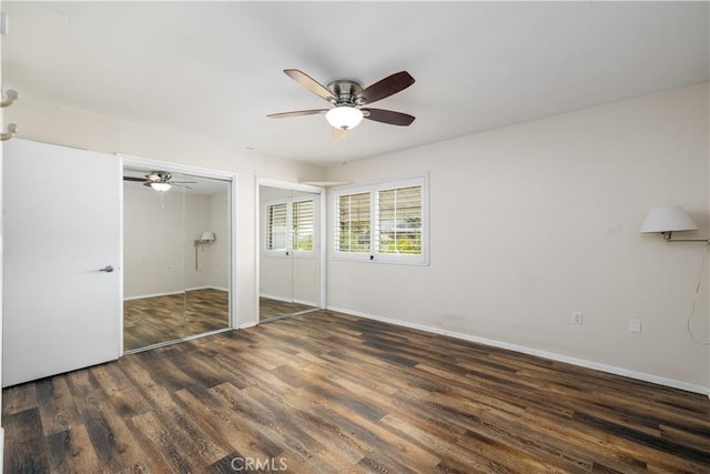 unfurnished bedroom featuring ceiling fan and dark hardwood / wood-style flooring