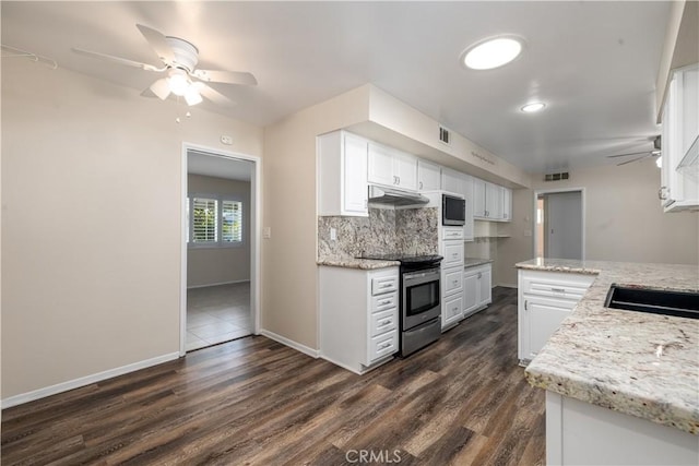 kitchen featuring dark wood-type flooring, light stone countertops, appliances with stainless steel finishes, tasteful backsplash, and white cabinetry