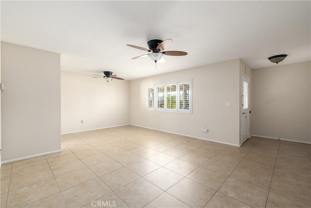 tiled spare room with ceiling fan