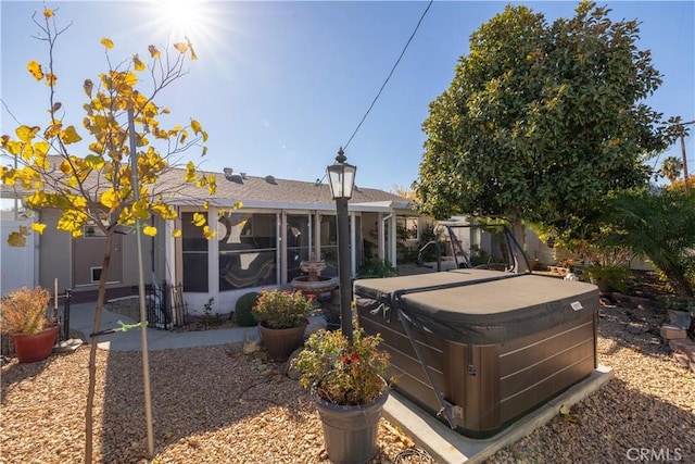 back of property with a patio area and a hot tub