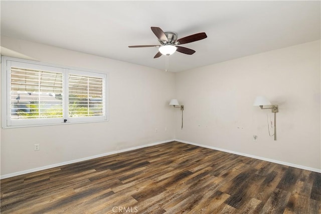 spare room featuring dark hardwood / wood-style floors and ceiling fan