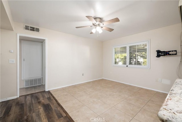 empty room with light hardwood / wood-style floors and ceiling fan