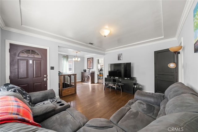 living room featuring hardwood / wood-style floors, a chandelier, and ornamental molding