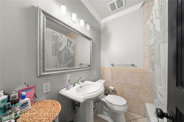 full bathroom with shower / bath combo, crown molding, tile patterned flooring, toilet, and tile walls