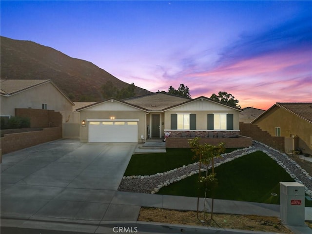 ranch-style home with a garage, fence, concrete driveway, and stucco siding