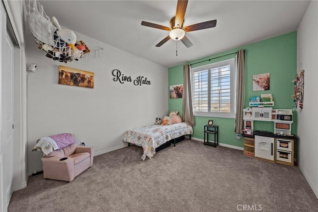 carpeted bedroom featuring baseboards and ceiling fan