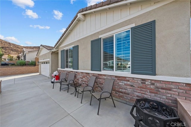 view of patio / terrace featuring a garage and driveway