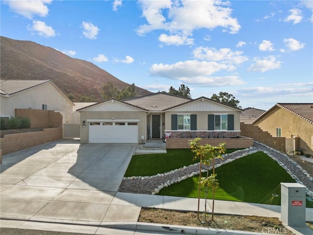 single story home with stucco siding, driveway, fence, a front yard, and an attached garage