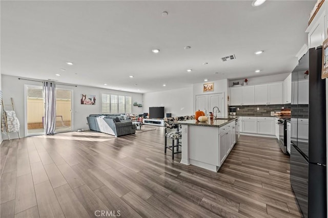 29707 Wolf Glen Ct, Winchester, CA 92596 - kitchen with a sink, open floor plan, white cabinetry, recessed lighting, and dark wood finished floors