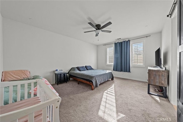 bedroom with carpet flooring, visible vents, a ceiling fan, and baseboards