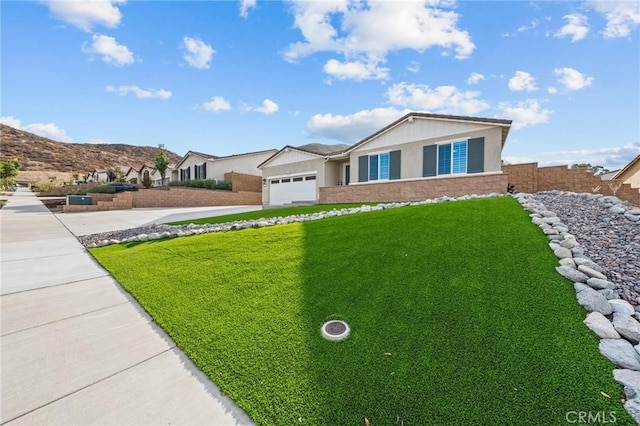 single story home with a garage, a front yard, and driveway