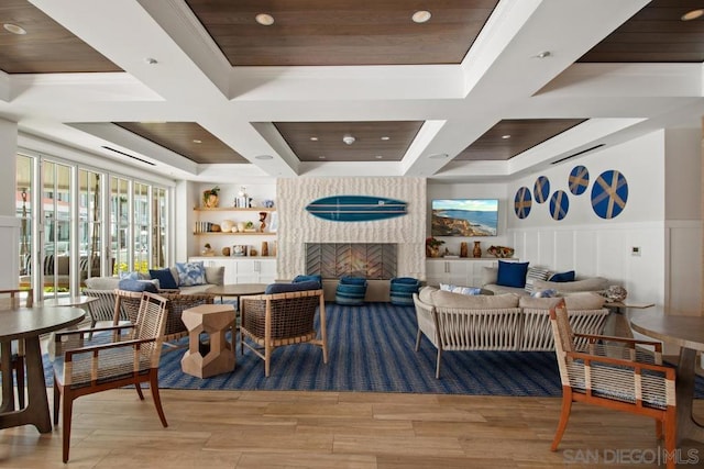 dining room with beamed ceiling, coffered ceiling, and light hardwood / wood-style floors