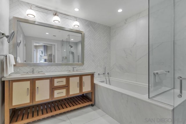 bathroom featuring separate shower and tub, backsplash, tile walls, vanity, and tile patterned floors