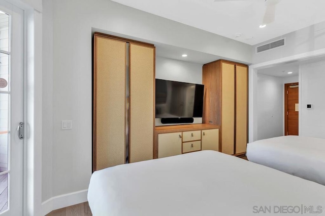 bedroom featuring light hardwood / wood-style flooring and ceiling fan