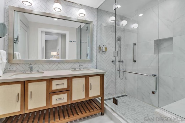 bathroom with a shower with door, decorative backsplash, and vanity