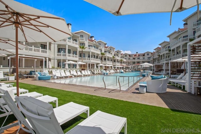 view of pool featuring a yard and a patio