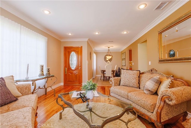 living room with light hardwood / wood-style floors and ornamental molding