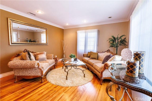 living room featuring wood-type flooring and crown molding