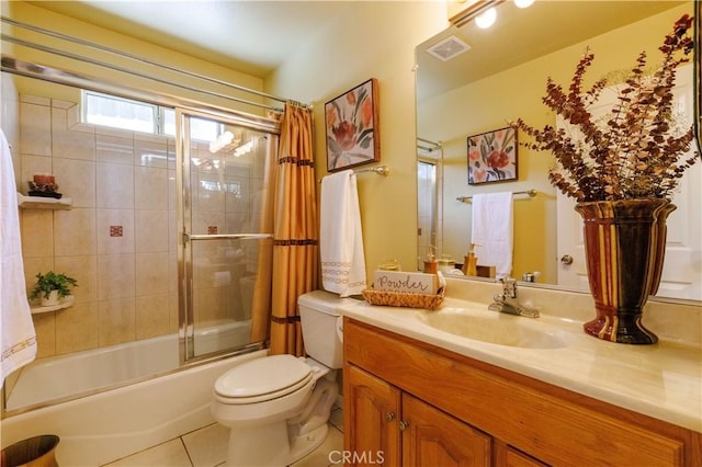 full bathroom with toilet, vanity, tile patterned floors, and bath / shower combo with glass door