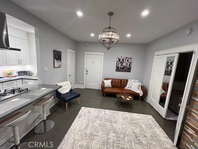 living room featuring french doors and a chandelier