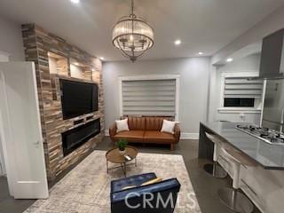 living room with a fireplace and a chandelier