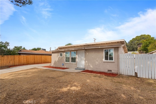 back of property with a patio area