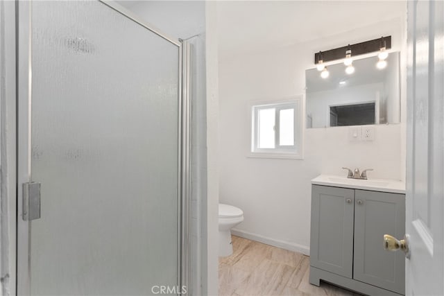 bathroom featuring vanity, toilet, and walk in shower