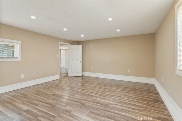 unfurnished room featuring light hardwood / wood-style floors and a healthy amount of sunlight