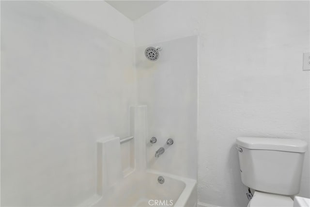 bathroom with toilet and bathing tub / shower combination